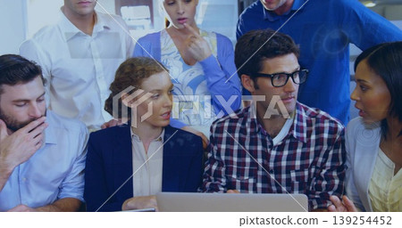 Discussing project ideas coworkers leaning toward laptop in conference room, business casual Discussing project ideas coworkers leaning toward laptop in conference room, business casual 139254452