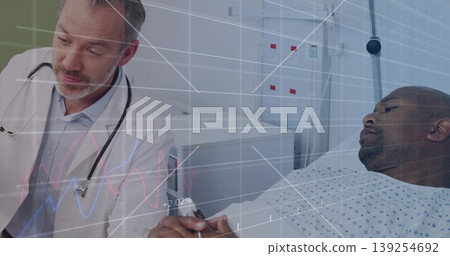 Examining mid-adult male patient wrist on bed in hospital room, with stethoscope clipboard Examining mid-adult male patient wrist on bed in hospital room, with stethoscope clipboard 139254692