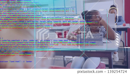 Typing student in striped shirt working on laptop at classroom desk, with tablet apple code overlay Typing student in striped shirt working on laptop at classroom desk, with tablet apple code overlay 139254724