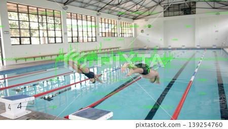 Diving two swimmers launching from blocks into lanes at pool, with windows and lane dividers Diving two swimmers launching from blocks into lanes at pool, with windows and lane dividers 139254760