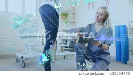 Examining patient fitted with prosthetic leg using tablet in rehab room, data overlays, copy space Examining patient fitted with prosthetic leg using tablet in rehab room, data overlays, copy space 139254770