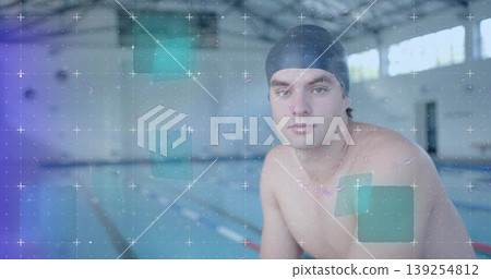 Sitting swimmer wearing black swim cap and trunks at pool edge by lane dividers, copy space Sitting swimmer wearing black swim cap and trunks at pool edge by lane dividers, copy space 139254812