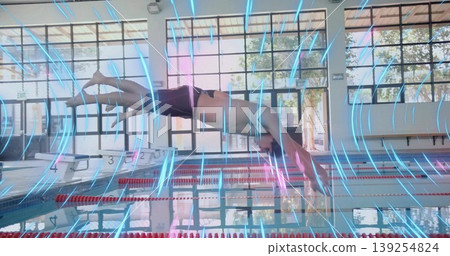 Diving athlete wearing trunks executing dive in pool, with starting blocks and lane dividers Diving athlete wearing trunks executing dive in pool, with starting blocks and lane dividers 139254824