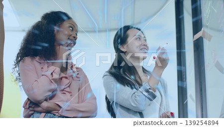 Writing team on glass board with notes at modern office, with red marker, data overlay Writing team on glass board with notes at modern office, with red marker, data overlay 139254894