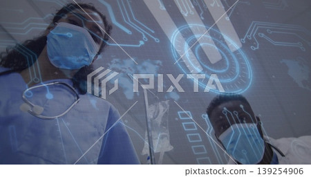 Leaning masked professionals in scrubs inspecting patient in exam room, with stethoscope iv bag 139254906
