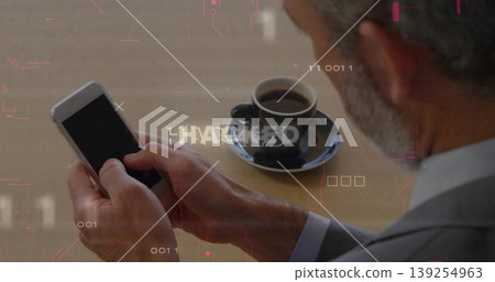 Gripping smartphone senior man wearing suit viewing hacked code warning with espresso cup at desk Gripping smartphone senior man wearing suit viewing hacked code warning with espresso cup at desk 139254963