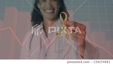 Smiling doctor wearing coat and stethoscope holding yellow ribbon in office with red data overlay Smiling doctor wearing coat and stethoscope holding yellow ribbon in office with red data overlay 139254981