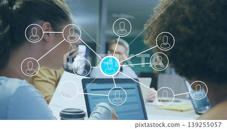 Collaborating four professionals using laptops in corporate conference room, with network overlay Collaborating four professionals using laptops in corporate conference room, with network overlay 139255057