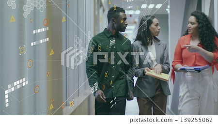 Walking business team navigating office hallway holding notepad and folder with hexagon overlays Walking business team navigating office hallway holding notepad and folder with hexagon overlays 139255062