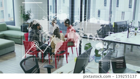 Brainstorming team discussing ideas around round table in open plan office with digital map overlay Brainstorming team discussing ideas around round table in open plan office with digital map overlay 139255137
