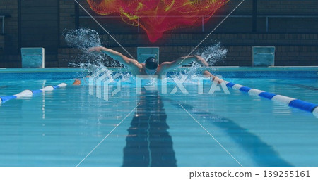 Swimming athlete wearing cap and goggles propelling butterfly stroke in pool with digital graphic Swimming athlete wearing cap and goggles propelling butterfly stroke in pool with digital graphic 139255161