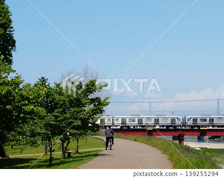 A train running through a park in early summer 139255294