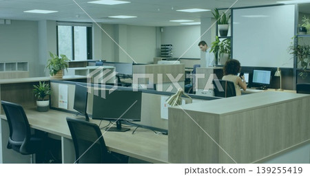 Working colleagues wearing smart clothes at monitors in open-plan office, copy space 139255419