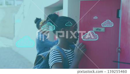 Unlocking schoolgirl wearing striped shirt and denim backpack at covered walkway, with red lockers Unlocking schoolgirl wearing striped shirt and denim backpack at covered walkway, with red lockers 139255460