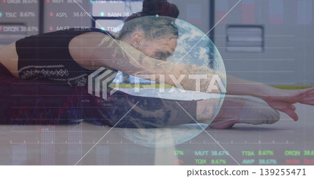 Stretching teen in black sportswear reaching foot in gym, with Earth graphic and stock charts Stretching teen in black sportswear reaching foot in gym, with Earth graphic and stock charts 139255471