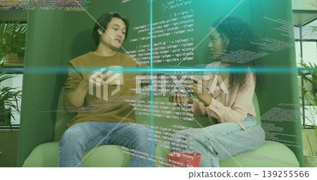 Coworkers discussing software code in break area, green chairs, coffee mugs and holographic overlay Coworkers discussing software code in break area, green chairs, coffee mugs and holographic overlay 139255566
