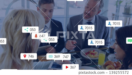 Professionals in suits reviewing tablet and discussing business plans in boardroom, with coffee 139255572
