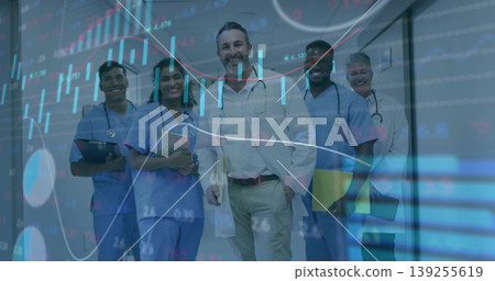 Walking medical team wearing white coats and scrubs in hospital corridor with stethoscopes, charts Walking medical team wearing white coats and scrubs in hospital corridor with stethoscopes, charts 139255619