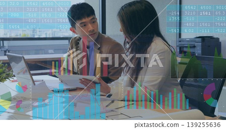 Two analysts collaborating at conference table, with laptop, tablet, blueprint and data overlays Two analysts collaborating at conference table, with laptop, tablet, blueprint and data overlays 139255636