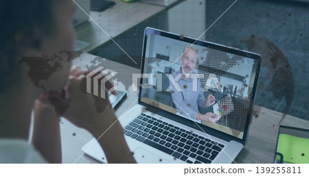 Watching woman listening to instructor demonstrating card trick at desk, with laptop and cards Watching woman listening to instructor demonstrating card trick at desk, with laptop and cards 139255811