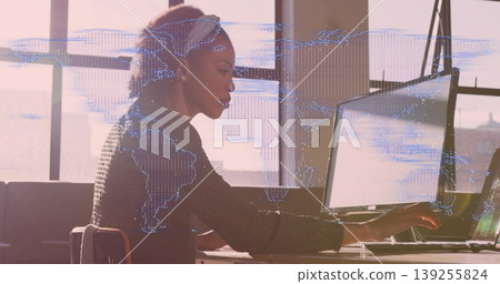 Woman in dark sweater typing on laptop in office, with holographic world map overlay, copy space Woman in dark sweater typing on laptop in office, with holographic world map overlay, copy space 139255824