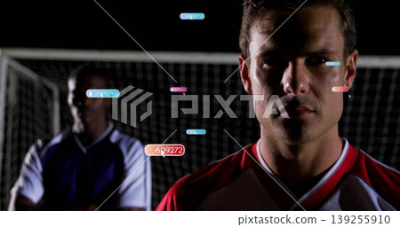 Tracking player wearing red-white jersey on night soccer field with net and data tags, copy space Tracking player wearing red-white jersey on night soccer field with net and data tags, copy space 139255910