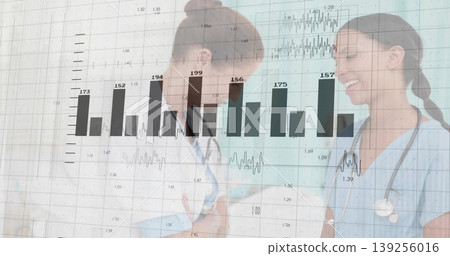 Analyzing metrics, two female doctors in scrubs with stethoscopes in corridor, with data overlay Analyzing metrics, two female doctors in scrubs with stethoscopes in corridor, with data overlay 139256016