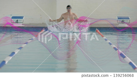 Breaststroke kicking swimmer in pool lane, with briefs, dividers, blocks 4 and 6, magenta overlay 139256068