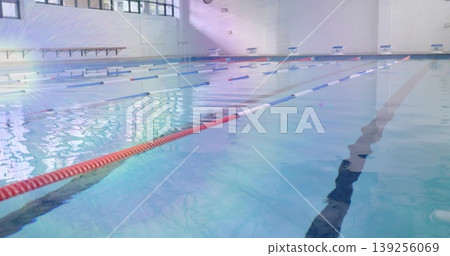 Showing empty pool reflecting sun, lined with lane ropes and ladder in aquatic center Showing empty pool reflecting sun, lined with lane ropes and ladder in aquatic center 139256069