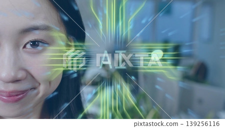 Smiling Chinese woman displaying neon-green AI overlay in office with desks and screens, copy space Smiling Chinese woman displaying neon-green AI overlay in office with desks and screens, copy space 139256116