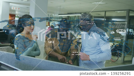 Analyzing three professionals pointing at map on transparent display table in open plan office 139256291