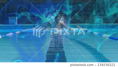 Performing butterfly stroke male swimmer splashing water in outdoor pool, with goggles, lane ropes Performing butterfly stroke male swimmer splashing water in outdoor pool, with goggles, lane ropes 139256322