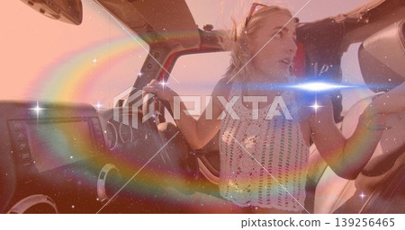 Driving woman holding wheel in red convertible on sunny road, with sunglasses and dashboard screen Driving woman holding wheel in red convertible on sunny road, with sunglasses and dashboard screen 139256465