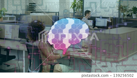Floating stylized brain overlay hovering over open-plan office desks with monitors and plants 139256502