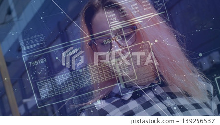 Data analyst analyzing holographic data panels in office space, with checkered shirt and eyeglasses Data analyst analyzing holographic data panels in office space, with checkered shirt and eyeglasses 139256537