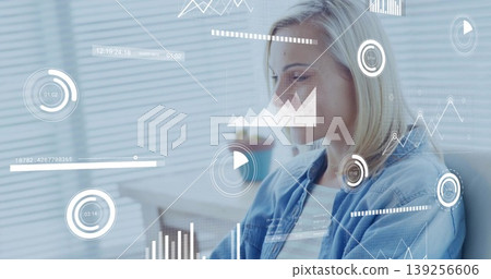 Mid adult woman analyzing floating data charts at office desk, with blinds and plant, copy space Mid adult woman analyzing floating data charts at office desk, with blinds and plant, copy space 139256606