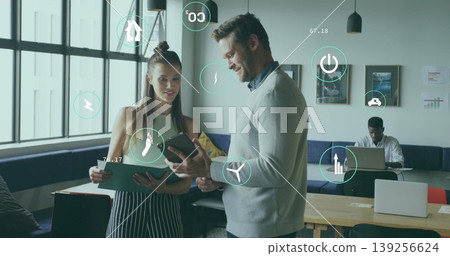Teenage girl and man reviewing data on tablet and folder in office lounge, with floating icons Teenage girl and man reviewing data on tablet and folder in office lounge, with floating icons 139256624