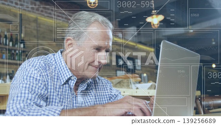 Typing senior man in checkered shirt using silver laptop at coffee shop, with floating digital data Typing senior man in checkered shirt using silver laptop at coffee shop, with floating digital data 139256689