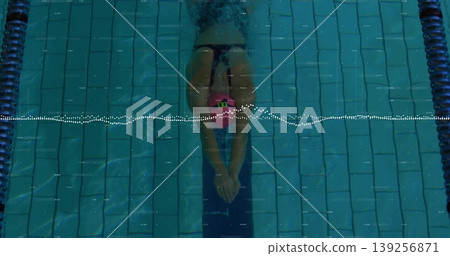 Female swimmer gliding underwater in pool, with pink swim cap, goggles, swimsuit, waveform overlay Female swimmer gliding underwater in pool, with pink swim cap, goggles, swimsuit, waveform overlay 139256871