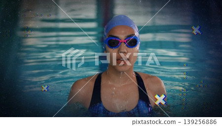 Gazing swimmer wearing racing swimsuit, cap and tinted goggles in competition pool, glitch effect Gazing swimmer wearing racing swimsuit, cap and tinted goggles in competition pool, glitch effect 139256886