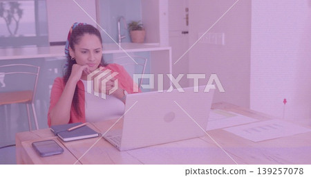 Holding coffee mug and viewing laptop screen at home kitchen table, with smartphone and documents Holding coffee mug and viewing laptop screen at home kitchen table, with smartphone and documents 139257078
