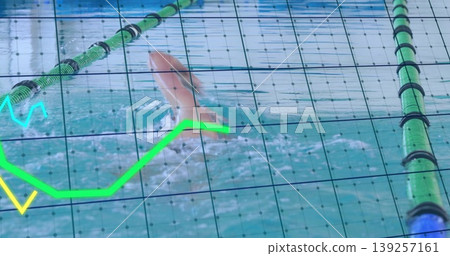 Swimming male athlete executing freestyle stroke in pool lane, with grid and neon chart overlays 139257161