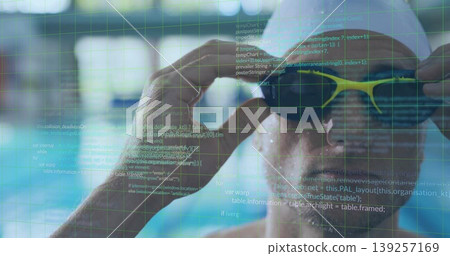 Adjusting male swimmer wearing cap tightening yellow goggles at pool lanes, code grid, copy space Adjusting male swimmer wearing cap tightening yellow goggles at pool lanes, code grid, copy space 139257169