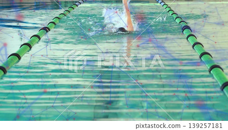 Swimming solo swimmer performing laps at lap pool, with swim cap, goggles, swimsuit and lane ropes Swimming solo swimmer performing laps at lap pool, with swim cap, goggles, swimsuit and lane ropes 139257181