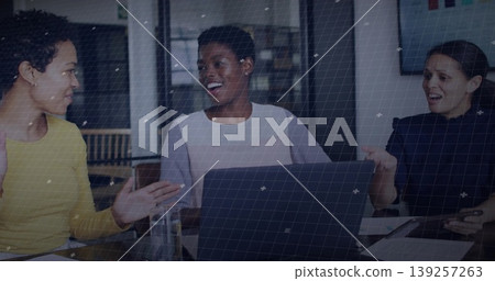Brainstorming businesswomen sharing ideas in office meeting room, with laptop and tablet Brainstorming businesswomen sharing ideas in office meeting room, with laptop and tablet 139257263
