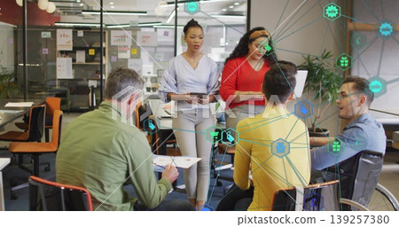 Five business professionals collaborating in office, with charts, sticky notes and data icons Five business professionals collaborating in office, with charts, sticky notes and data icons 139257380