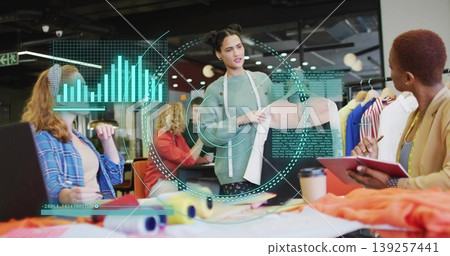 Presenting designer holding pastel pink blouse sample at design studio table, holographic overlays Presenting designer holding pastel pink blouse sample at design studio table, holographic overlays 139257441