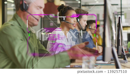 Speaking female agent in striped blouse and headset at office desk, with monitors and code overlay Speaking female agent in striped blouse and headset at office desk, with monitors and code overlay 139257510