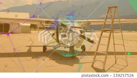 Single-engine prop plane standing on apron, with runway markings, stepladder and network overlay 139257526