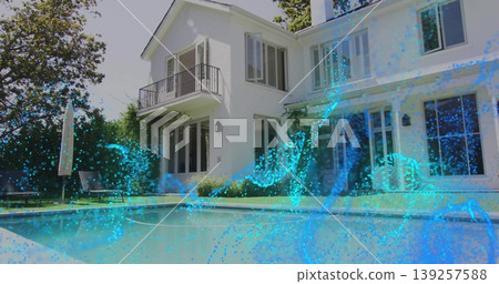 Two-story house standing in backyard, showing pool with closed umbrella and chairs under blue waves 139257588